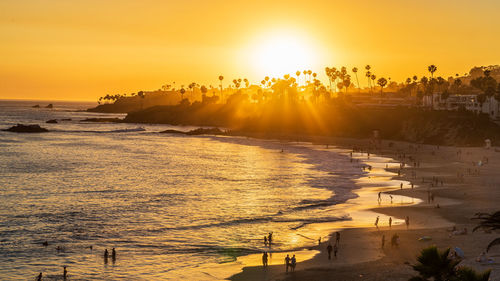 Scenic view of beach against sky during sunset