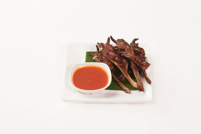 High angle view of breakfast on table against white background