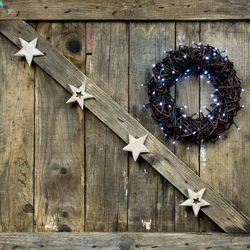 Close-up of christmas decorations hanging on wood