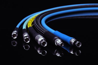 Close-up of electric light on table against black background