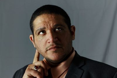 Portrait of young man against gray background
