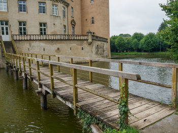 Bridge over river against buildings