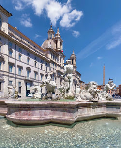 Piazza navona in rome on a sunny day. baroque architecture and marble fountain with statues.