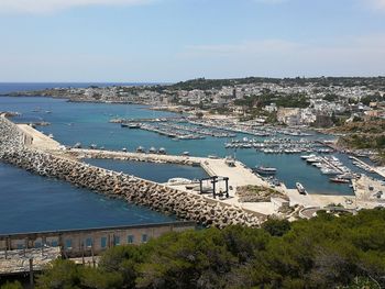 High angle view of sea and cityscape against sky