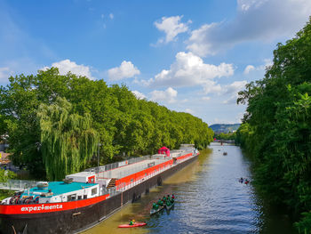 Scenic view of river amidst trees against sky