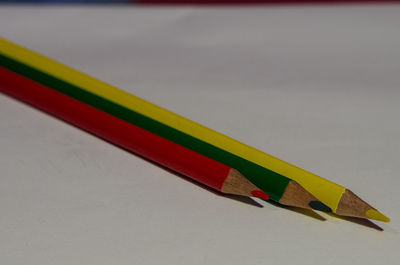 Close-up of multi colored pencils over white background