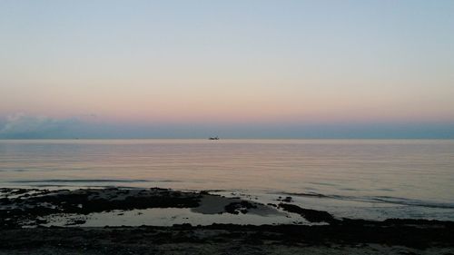 Scenic view of sea against clear sky during sunset