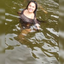 Portrait of smiling young woman in lake