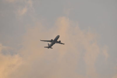 Low angle view of airplane flying in sky