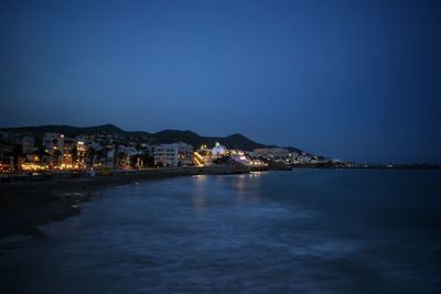 Illuminated city at waterfront