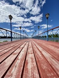 Surface level of pier on bridge against sky