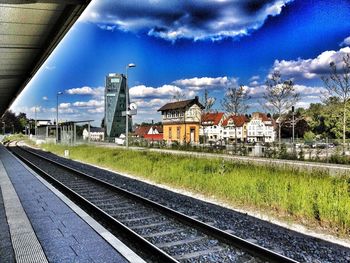 Railroad track against cloudy sky