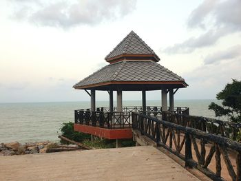 Lifeguard hut on beach against sky