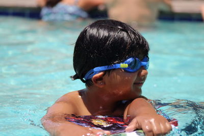 Portrait of boy swimming in pool