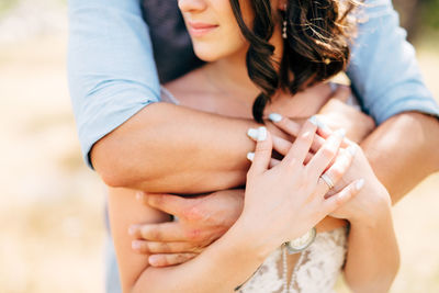 Midsection of couple holding hands