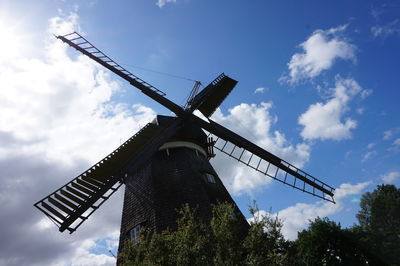 Low angle view of traditional windmill against sky