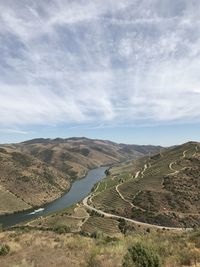 Scenic view of river against fluid blue sky