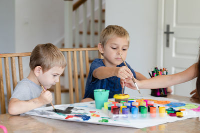 Boy sitting on table