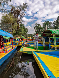 Boats in river against sky