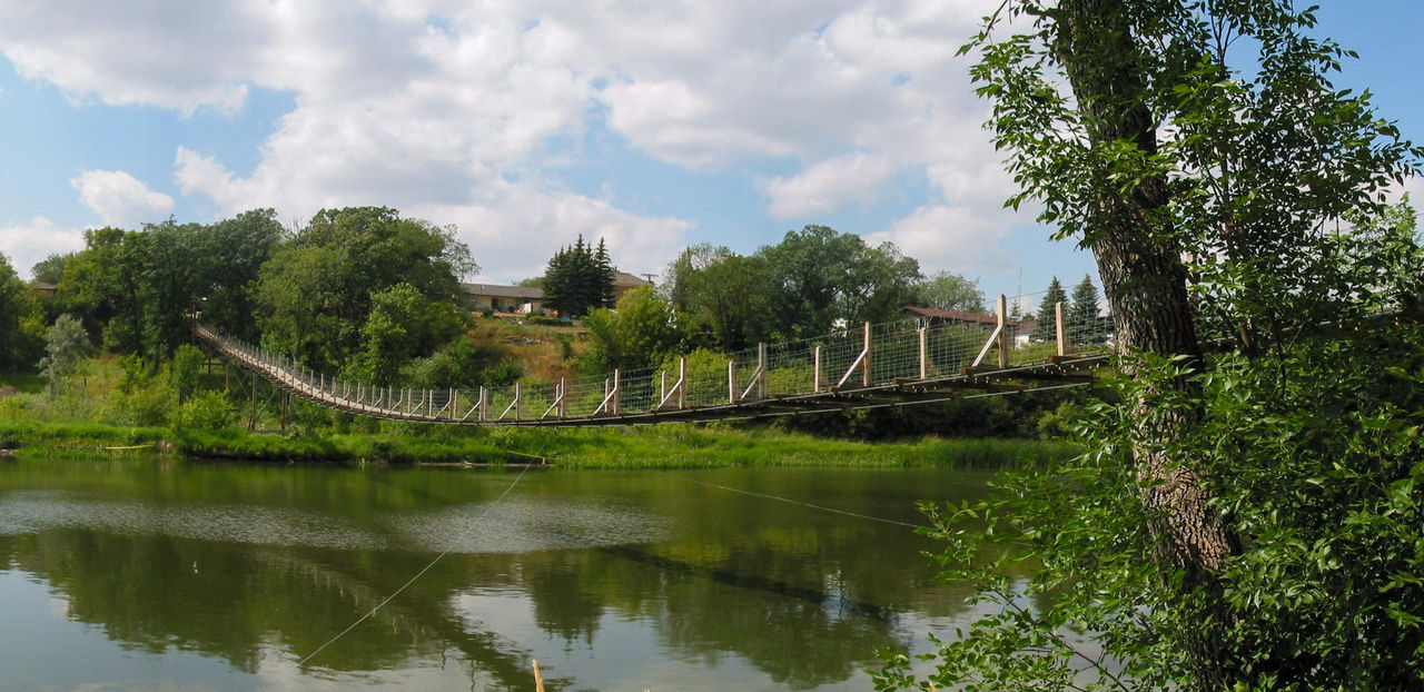 water, tree, plant, reflection, sky, river, nature, cloud, environment, architecture, travel destinations, no people, scenics - nature, landscape, beauty in nature, travel, reservoir, tranquility, built structure, waterway, pond, body of water, tourism, outdoors, green, bridge, forest, land, history, day, park