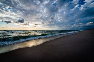 Scenic view of beach against sky during sunset