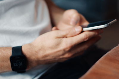 Midsection of man using mobile phone