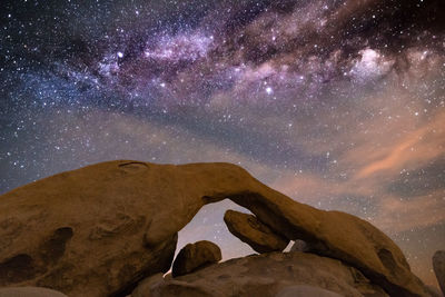 Scenic view of mountains against sky at night