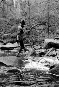 Rear view of man standing on rock