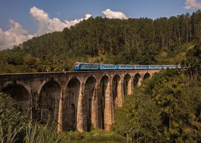 Train on bridge against sky