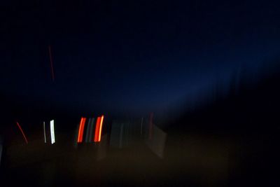 Low angle view of illuminated lights against sky at night