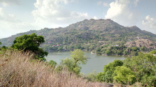 Scenic view of lake and mountains against sky