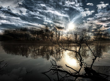 Scenic view of lake against sky during sunset