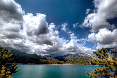 Scenic view of calm lake against mountain range