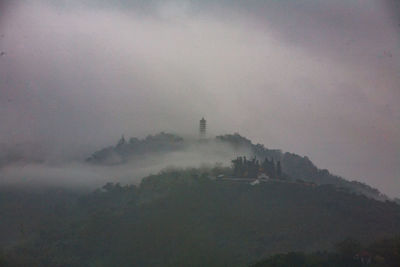 Scenic view of pagoda ci en pagoda mountain against cloudy sky