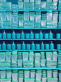 Containers and dispensers on shelf