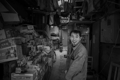 Portrait of smiling young woman standing at market