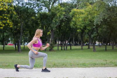 Full length of woman exercising in park