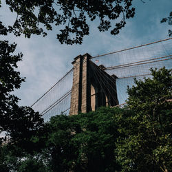 Low angle view of bridge and buildings against sky