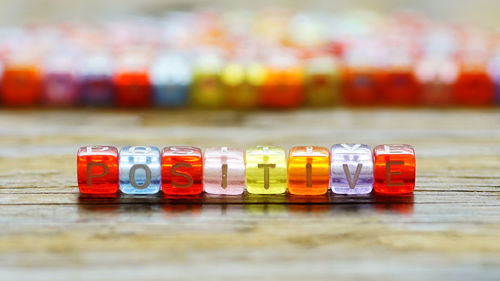 Close-up of multi colored bottles on table