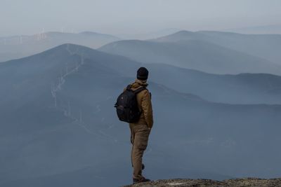 Rear view of man standing on mountain