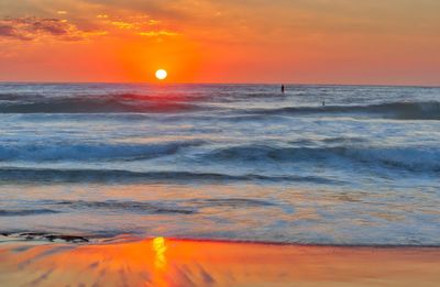 Scenic view of sea against orange sky