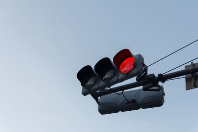 Low angle view of road signal against clear sky