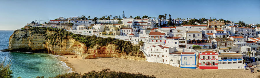 Town by sea against sky in city