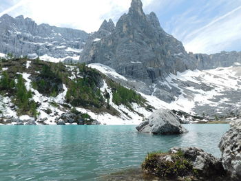 Scenic view of lake and mountains against sky