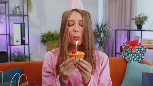 Young woman holding ice cream cone