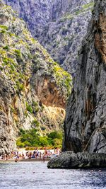 Group of people on rock by sea