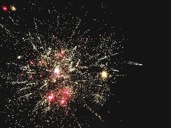 Low angle view of firework display at night