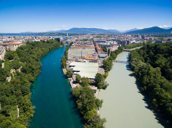 High angle view of river amidst buildings against clear sky