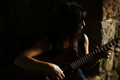 Mature woman playing guitar