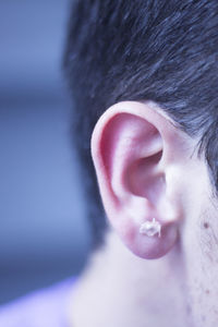 Close-up of man ear with adhesive bandage 